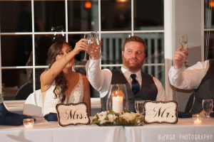 Newlyweds raising champagne glasses for a toast
