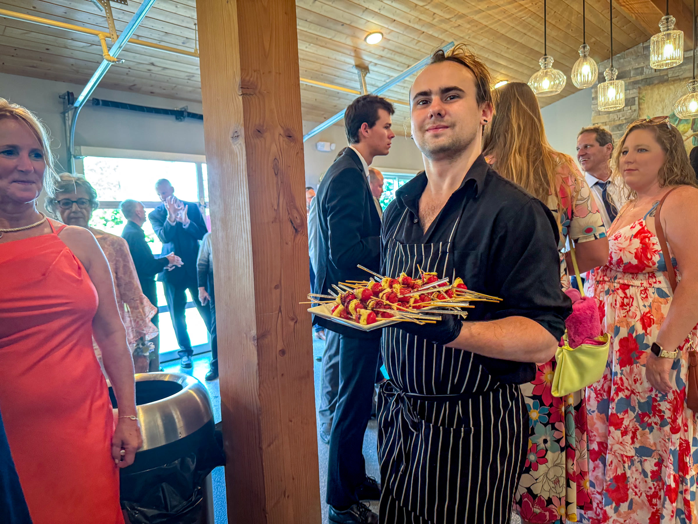 A Bailey Family Catering team member serving appetizers to guests