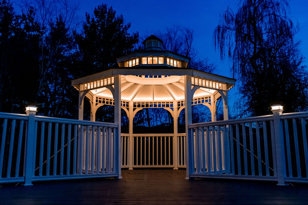The Willow gazebo illuminated with warm string lights at night