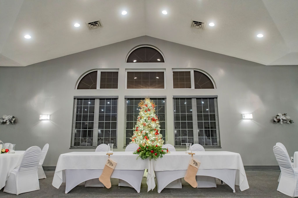 Head table decorated for a holiday event with a Christmas tree