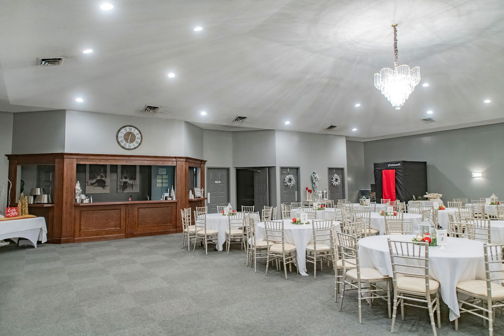 Event hall with round tables and wooden bar area